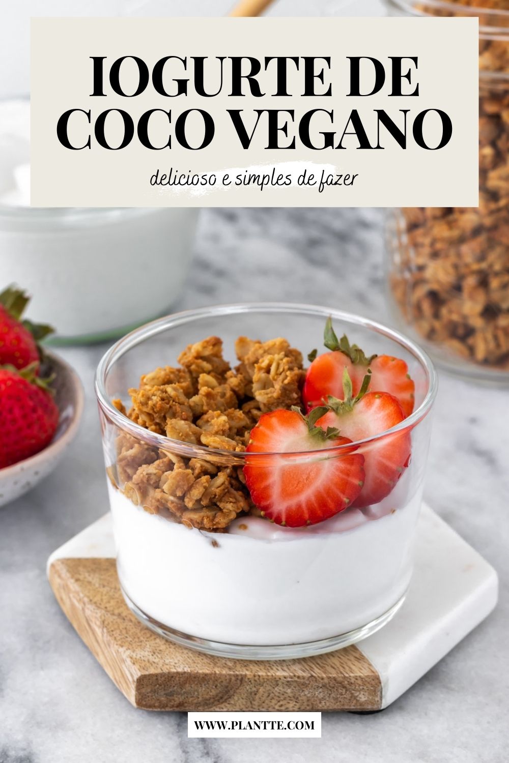 iogurte de coco caseiro servido em um pote com granola e morangos frescos cortados na metade