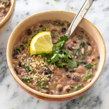 sopa de feijão com arroz e leite de coco servida com limão, sementes e salsinha fresca picada